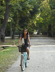 Image showing Woman riding a bicycle