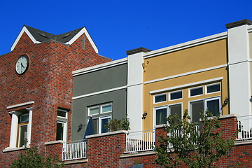 Image showing Clock Tower next to Modern Buildings