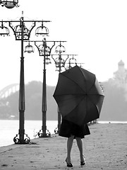 Image showing Lady with umbrella on promenade