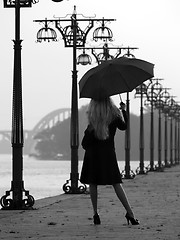 Image showing Blonde with umbrella on promenade