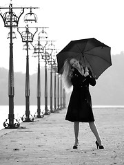 Image showing Blonde with umbrella on promenade