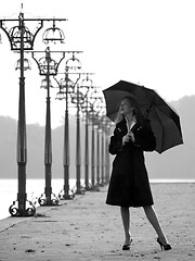 Image showing Blonde with umbrella on promenade