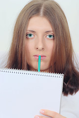 Image showing Cute girl with notebook and pencil