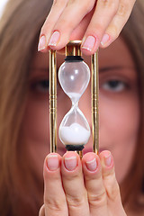 Image showing The girl with a sand clock