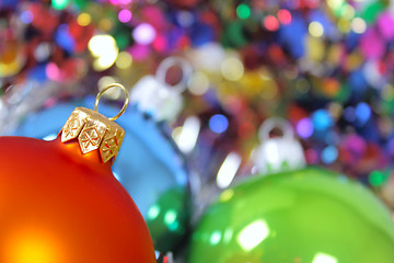 Image showing New Year's fur-tree toys against a multi-coloured tinsel