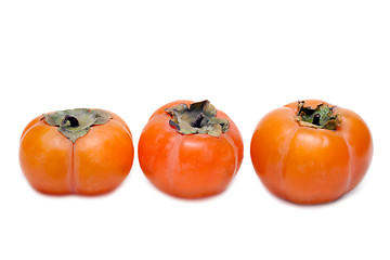 Image showing Three persimmons put in row