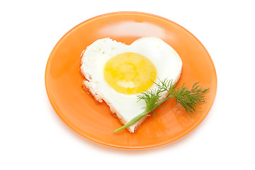 Image showing Fried egg in form heart on plate with dill