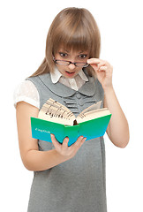 Image showing Young girl reads english and wonders