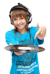 Image showing Girl in earphone with vinyl disk in hand