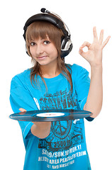 Image showing Girl in earphone with vinyl disk in hand, ok