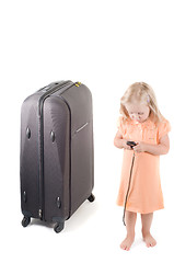 Image showing Little girl and suitcase in studio