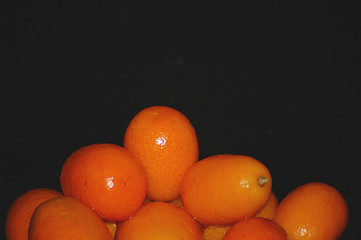 Image showing orange fruit on black