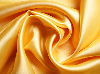 Image showing Smooth elegant golden satin as background 