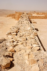 Image showing Wall of the ancient fortress in the desert during sandstorm