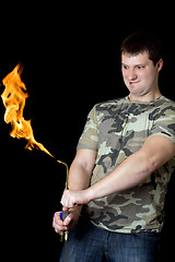 Image showing Crazy young man with a gas torch