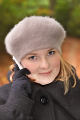 Image showing Cute young woman in forest talking on cell