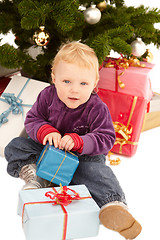 Image showing Cute little girl opening christmas gifts