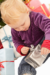 Image showing Christmas Presents - Little girl opening gifts