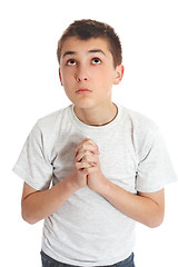 Image showing Boy in prayer looks to heaven for answers