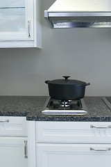 Image showing A very neatly clean kitchen with a casserole pot on the stove