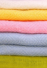 Image showing Pile of gentle folded shawls (scarfs)