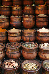 Image showing Beautifully carved handmade pots full of aromatic spices on the 