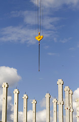 Image showing Construction site with a crane hook and pillars