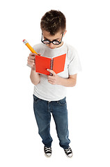 Image showing Boy writing in notebook