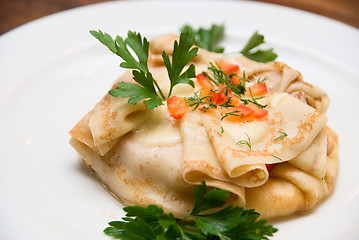 Image showing Close up of Pancakes with greenery