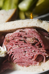 Image showing corned beef pastrami combination sandwich rye bread pickles