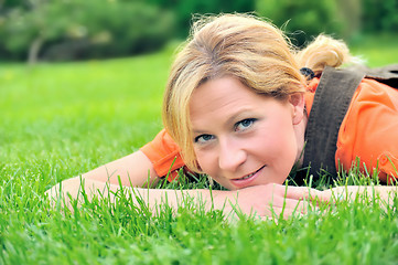 Image showing Young woman relaxing on the grass