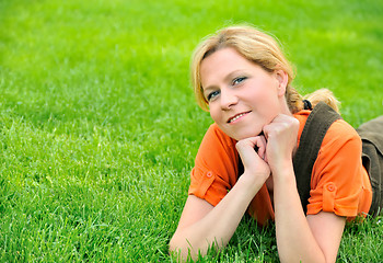 Image showing Young woman relaxing on the grass