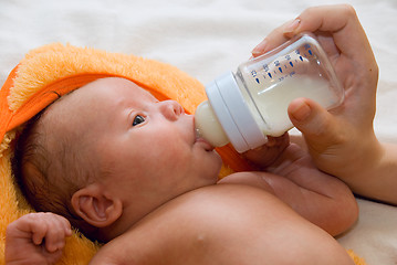 Image showing Baby boy and feeding bottle