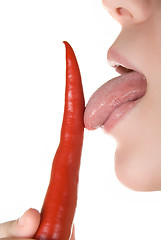 Image showing licking chili pepper 