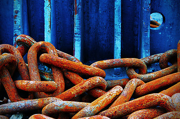 Image showing Red chains and blue wall.