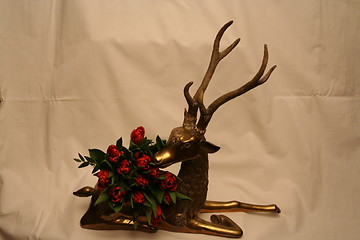 Image showing Red deer with tulips