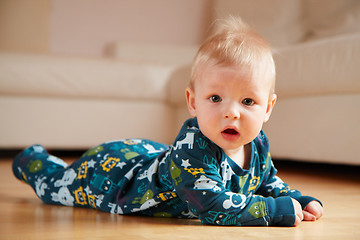 Image showing 6 mobth old baby crawling on floor at home