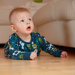 Image showing 6 mobth old baby crawling on floor at home