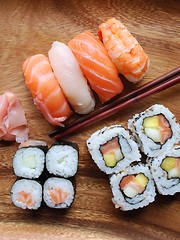 Image showing Sushi - Japonese food (on a wooden plate)