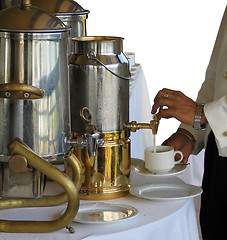 Image showing Pouring milk in a cup of tea