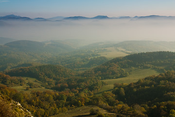 Image showing green valley with mountains in fog