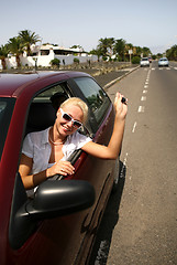 Image showing young blonde woman with keys in the car