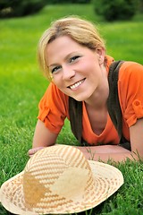 Image showing Young woman laying on the grass