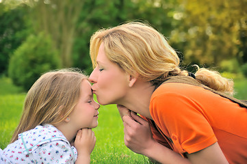 Image showing Mother is kissing her daughter