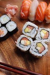 Image showing Sushi - Japonese food (on a wooden plate)