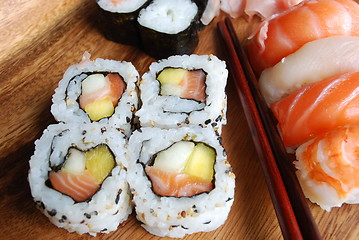 Image showing Sushi - Japonese food (on a wooden plate)