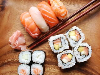 Image showing Sushi - Japonese food (on a wooden plate)