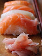 Image showing Sushi - Japonese food (on a wooden plate)