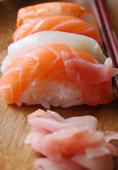 Image showing Sushi - Japonese food (on a wooden plate)