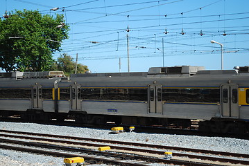 Image showing Gray train passing a local village